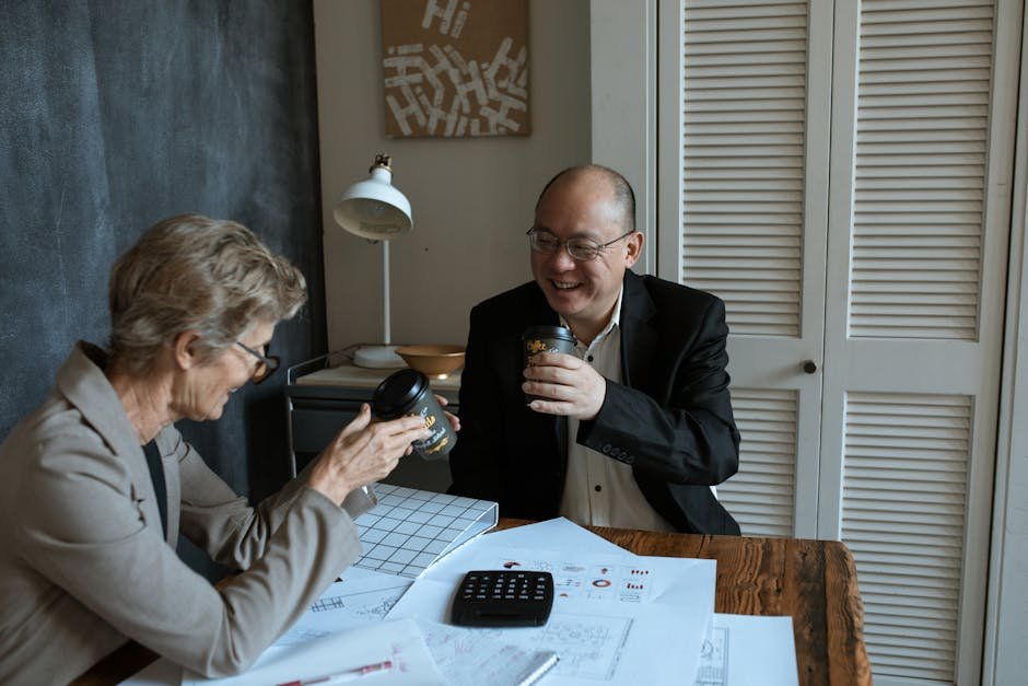 台馬跨境稅務：Business professionals sharing coffee and charts at an offic