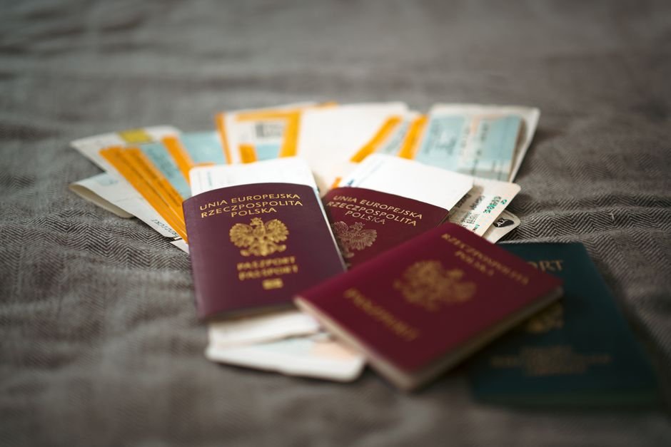 MM2H 適合誰：Close-up of Polish passports and travel tickets symbolizing